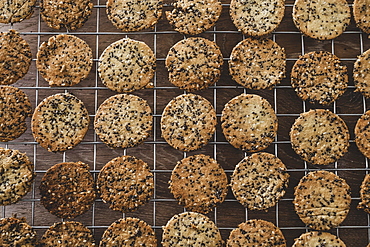 High angle close up of freshly baked seeded crackers on a baking tray, England