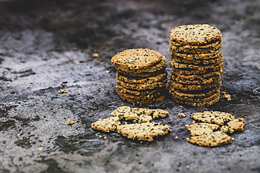 High angle close up of stack of freshly baked seeded crackers, England