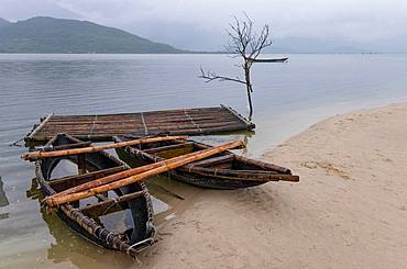 Traditional boats on sandy shore near Da Nang, Vietnam