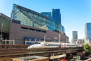 Shinkansen Bullet Train on an elevated section of track next to the Tokyo International Forum by Yurakucho Station, Tokyo, Japan