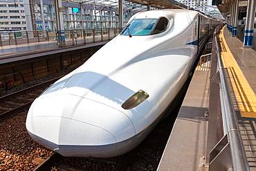 White Shinkansen Bullet Train waiting at a platform of Tokyo Station, Japan