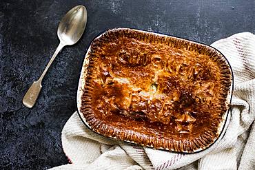 High angle close up of freshly baked Chicken Pie and silver spoon