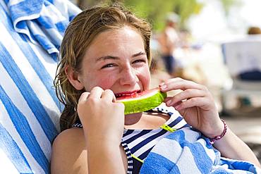 A teenage girl eating watermelon, Grand Cayman, Cayman Islands