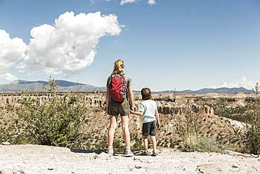 Brother and sister holding hands visiting a prehistoric site in New Mexico