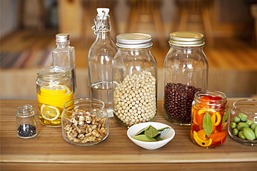 Close up of a selection of condiments and dried pulses in glass jars, Kyushu, Japan