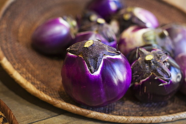 High angle close up of a selection of fresh purple aubergines in a farm shop, Kyushu, Japan