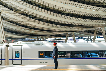 Guard by Maglev train in the railway station, Beijing, China