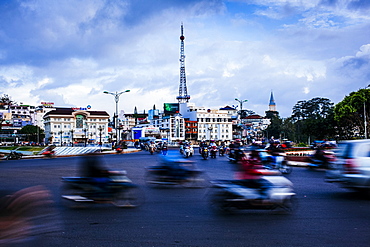 Urban scene with blurred motion of passing traffic and motorbikes on wide street, Vietnam