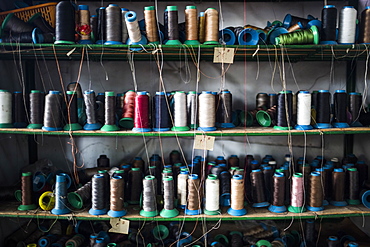 Close up of shelves of colorful thread for sewing shoe soles in a factory, Vietnam, Binh Duong