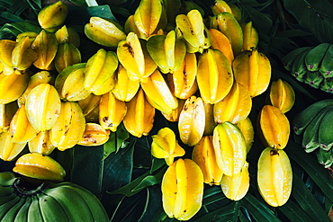 Close up of star fruits and green bananas for sale along the side of the road, Guam