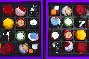 High angle close up of selection of bonbons in a purple and black box, Singapore