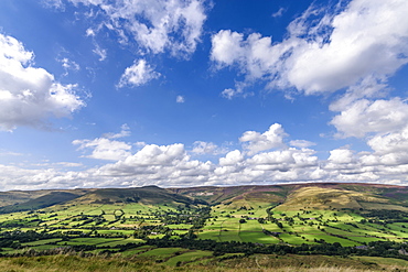 Landscape with fields and distant mountains under a cloudy sky, Peak District National Park, United Kingdom