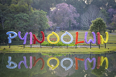 Colourful letters reflected in a lake in a park in Myanmar, Myanmar