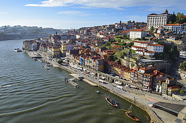 High angle view of coastal town with sailboat moored near harbour wall, Portugal