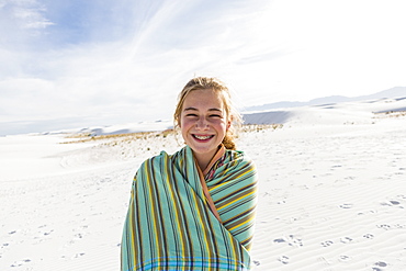 Teenage girl in a towel on the sand, White Sands National Monument, New Mexico, United States