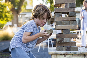 A young boy playing with giant jigsaw puzzle, United States