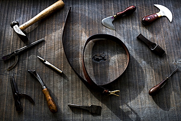 High angle close up of selection of saddle making hand tools, Berkshire, United Kingdom