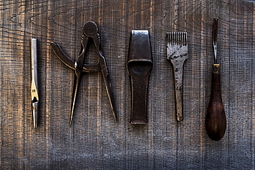 High angle close up of selection of saddle making hand tools, Berkshire, United Kingdom