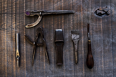 High angle close up of selection of saddle making hand tools, Berkshire, United Kingdom