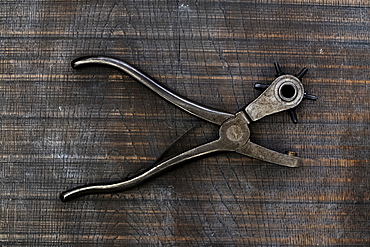 High angle close up of revolving leather hole punch, Berkshire, United Kingdom