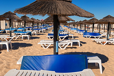 Beach parasols and sunloungers on the beach on Ilha de Tavira, Southern Algarve, Portugal