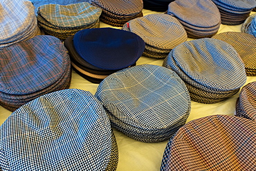 Cloth caps on sale in the Mercado Municipal, the main market in Tavira, Algarve, Portugal