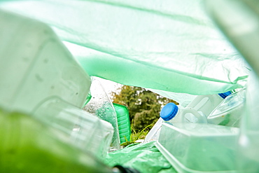 View from inside a plastic bag lying on the grass filled with plastic rubbish, Bristol, United Kingdom