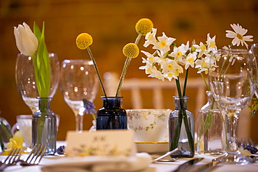 Close up of festive place setting for a naming ceremony in an historic barn