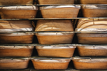 Artisan bakery making special sourdough bread, proving baskets on racks