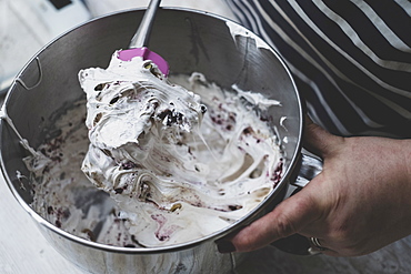 Cook folding egg whites into a baking mixture