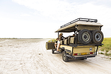 Thirteen year old leaning on safari vehicle, Botswana