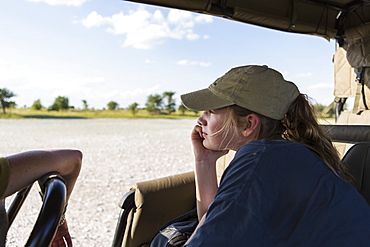 A teenage girl in a safari vehicle