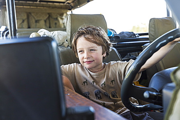 portrait of Six year old boy in safari vehicle