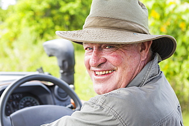 Portrait of smiling safari guide in a bush hat