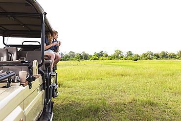 Thirteen year old girl on safari vehicle, Botswana