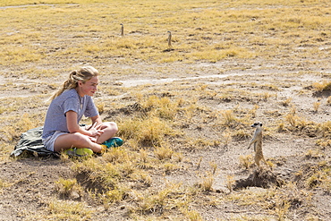 12 year old girl looking at Meerkats, Kalahari Desert, Makgadikgadi Salt Pans, Botswana