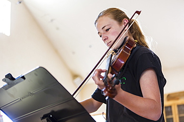 Teenage girl playing violin, New Mexico, United States