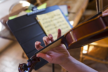 close up of hands playing violin, New Mexico, United States