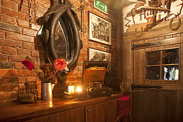 A hotel with old fashioned retro styled rooms, and rustic objects, bar with horse harness, Estonia