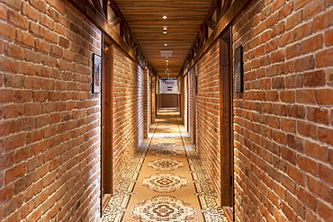 A hotel with old fashioned retro styled rooms, and rustic objects, corridor with patterned carpet, room doors, Estonia