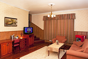 A hotel with old fashioned retro styled rooms, and rustic objects, sofa and chairs and television, Estonia