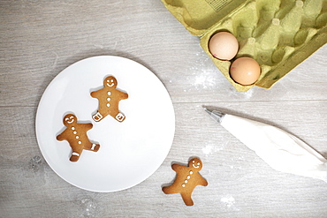 High angle close up of Gingerbread Men on a white plate