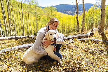 teenage girl embracing her English Cream Golden Retriever