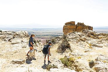 children hiking on Chimney Rock trail, through a protected canyon landscape, New Mexico, United States of America