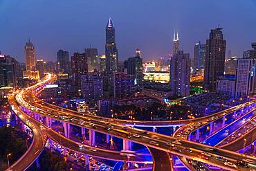 Elevated road junction and skyline of Shanghai, China at dusk, China