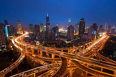 Elevated road junction and skyline of Shanghai, China at dusk, China