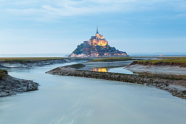 Mont St Michel at dusk on the tidal estuary