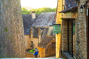 Young woman cyclist, Beynac-et-Cazenac, Beynac, Dordogne, France