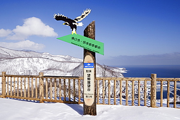 Wooden sign post in winter landscape