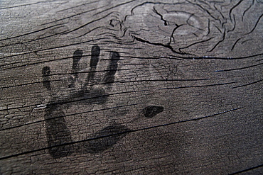 Hand print on wooden surface